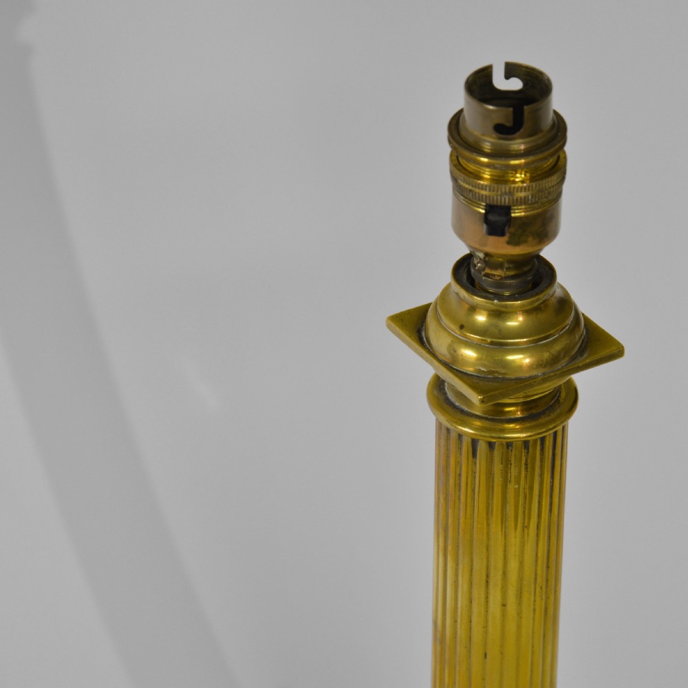 A fluted brass column table lamp base standing on a stepped square pedestal base. View IV