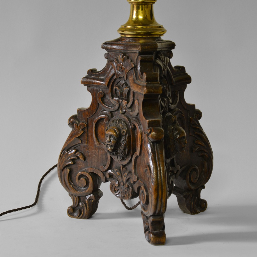 A Flemish carved oak table lamp base featuring a sculpted lion mask and a turned brass column. View II