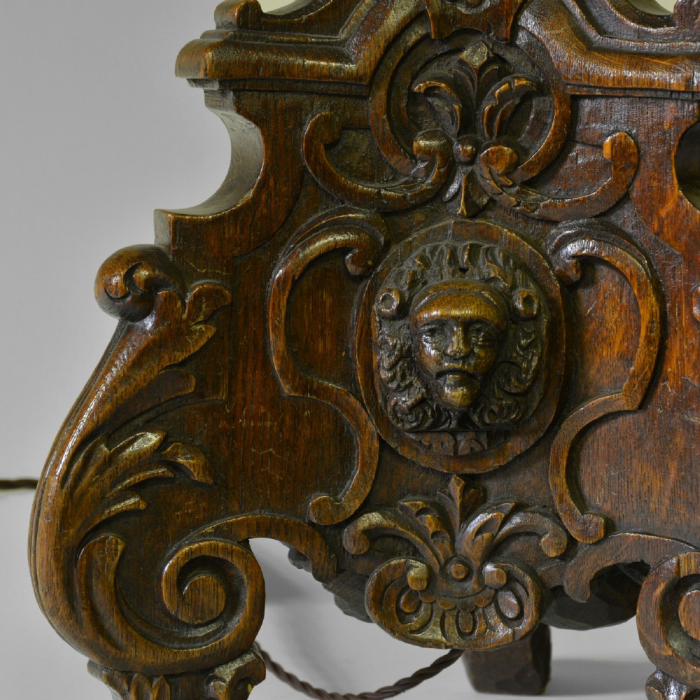 A Flemish carved oak table lamp base featuring a sculpted lion mask and a turned brass column. View III