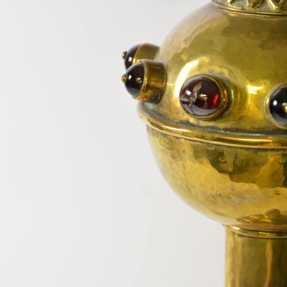 An ornate brass table lamp crafted in a French Gothic style featuring a scrollwork base, turned column, and a central spherical knop set with dark red cabochon accents. View III