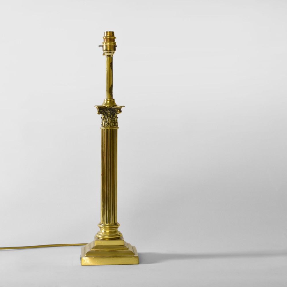 A Victorian brass table lamp designed as a fluted Corinthian column with a stepped base, topped with a pleated sage green fabric shade. View II