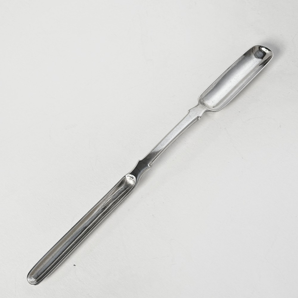 An 1827 Irish sterling silver double-ended marrow scoop with two narrow oblong troughs connected by a central handle.