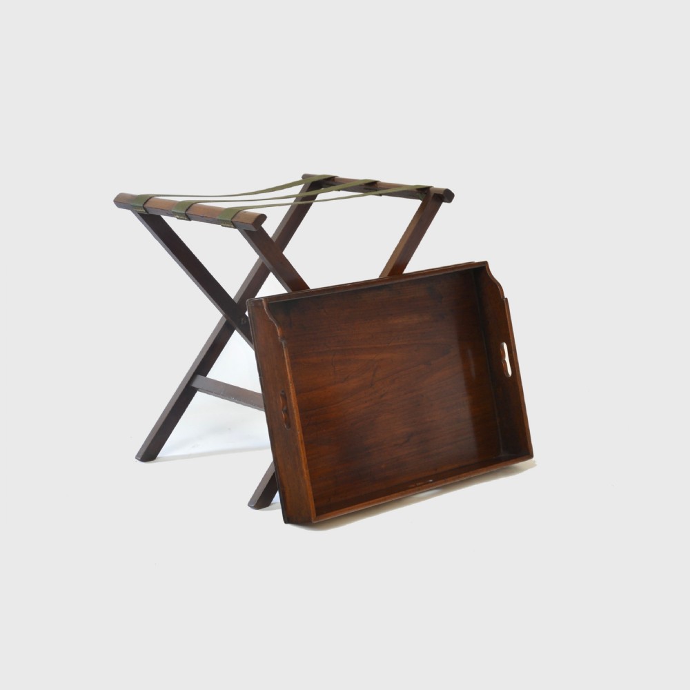 An 18th century Georgian mahogany butler tray featuring gallery sides with cut-out hand grips resting on a folding X-frame stand. View IV
