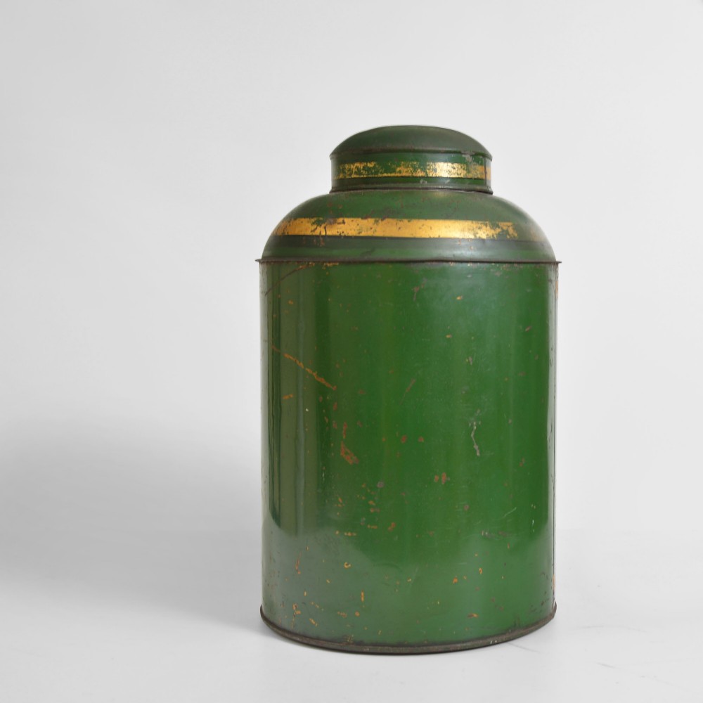 A cylindrical dark green antique tin tea canister featuring gilded bands and a prominent hand-painted number 24 on the front. View II