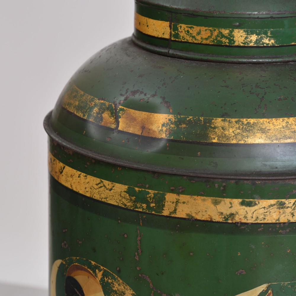 A cylindrical dark green antique tin tea canister featuring gilded bands and a prominent hand-painted number 24 on the front. View III