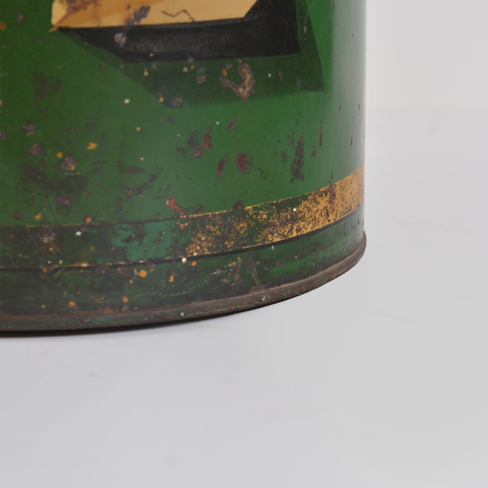 A cylindrical dark green antique tin tea canister featuring gilded bands and a prominent hand-painted number 24 on the front. View IV