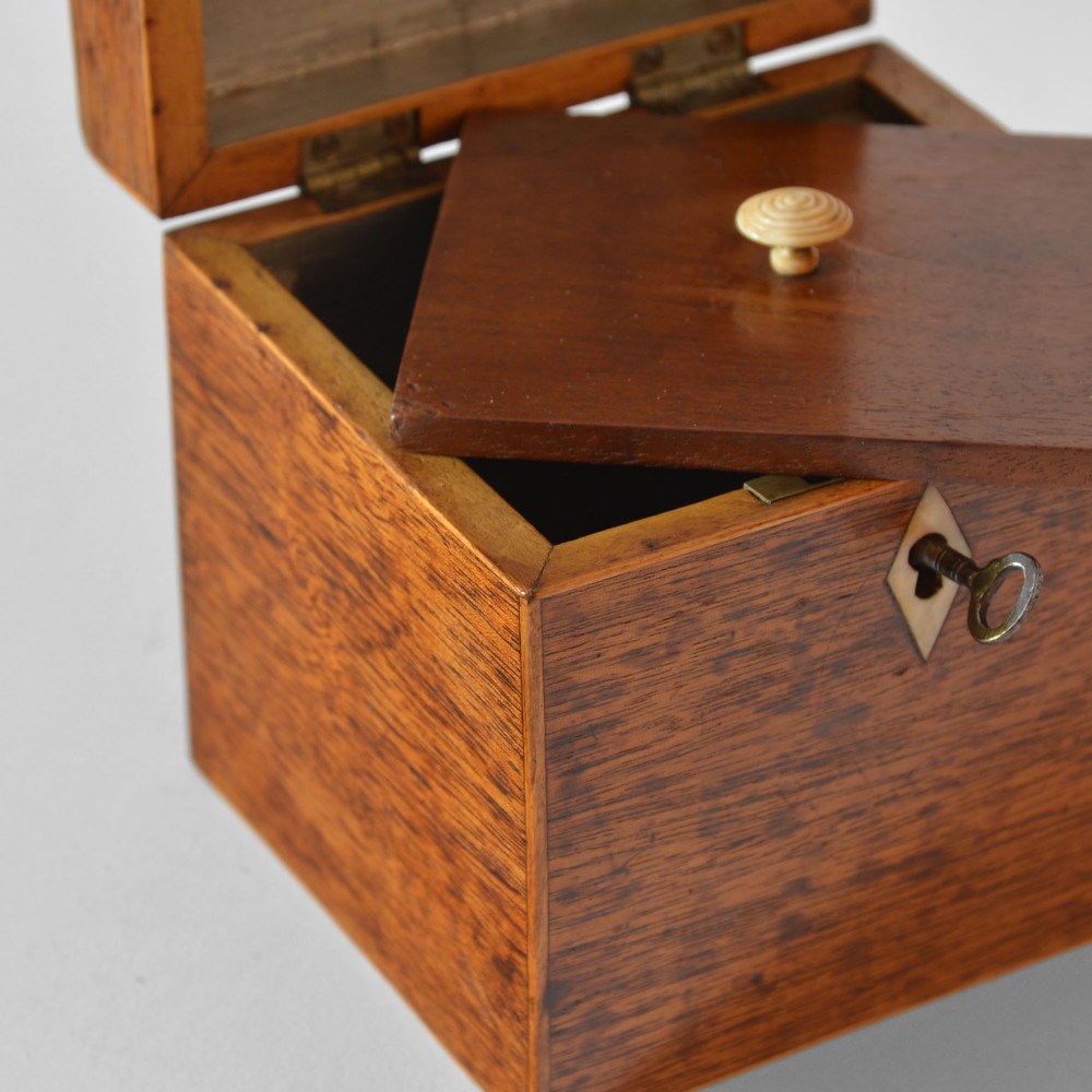 A cubic Georgian mahogany tea caddy featuring boxwood edge stringing, a diamond bone escutcheon, and an iron key. View IV