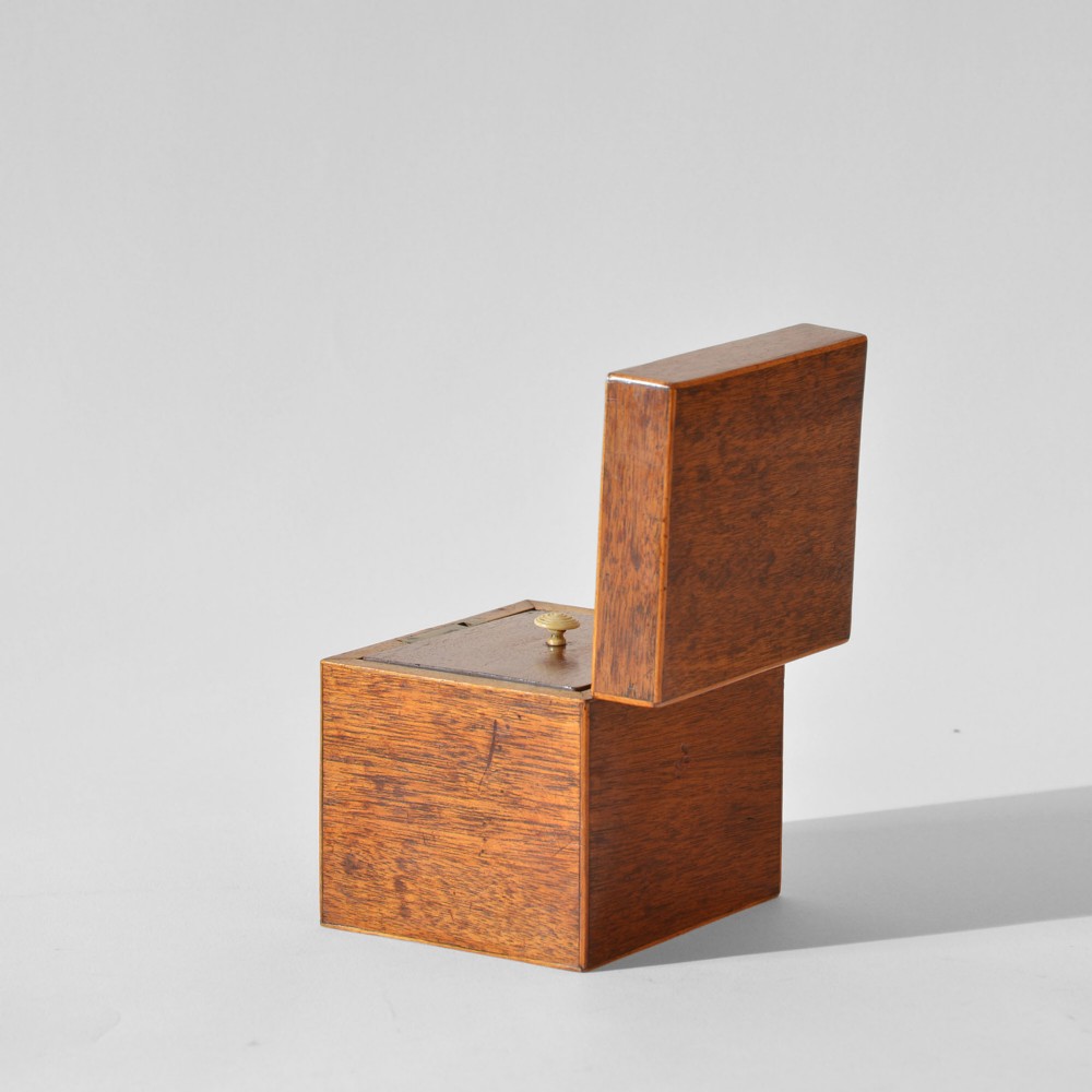 A cubic Georgian mahogany tea caddy featuring boxwood edge stringing, a diamond bone escutcheon, and an iron key. View V