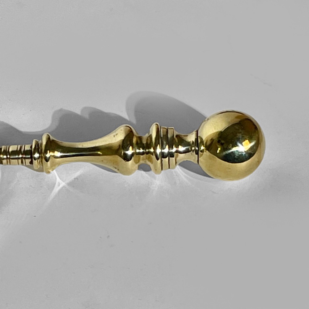 A 19th-century brass magnifying glass featuring a turned handle with a spherical finial and a circular convex lens. View II