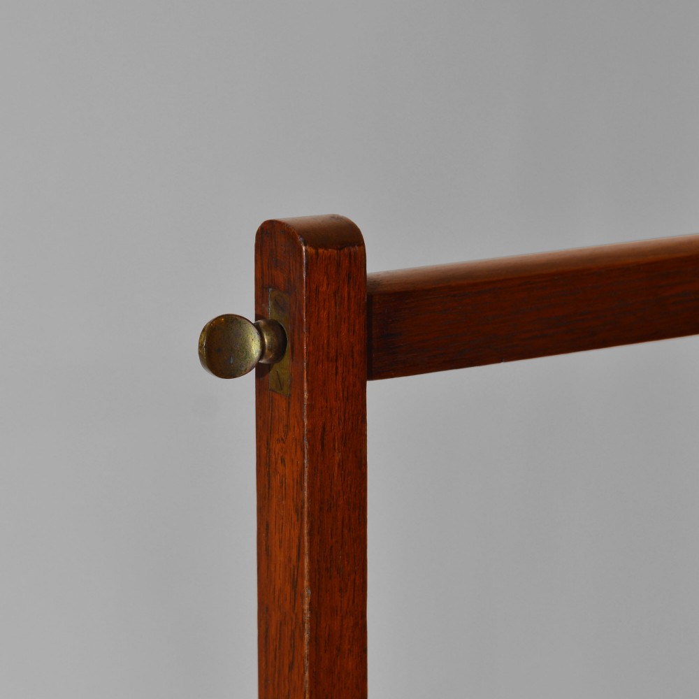 A 19th-century freestanding teak campaign towel rail featuring three horizontal bars, brass fittings, and splayed trestle feet against a plain background. View III