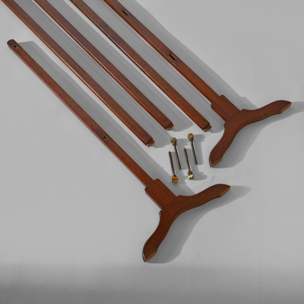 A 19th-century freestanding teak campaign towel rail featuring three horizontal bars, brass fittings, and splayed trestle feet against a plain background. View IV