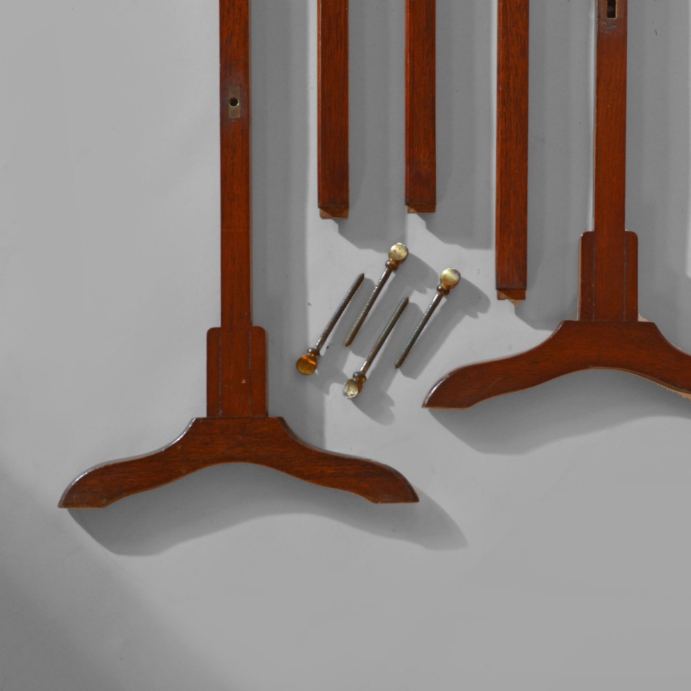 A 19th-century freestanding teak campaign towel rail featuring three horizontal bars, brass fittings, and splayed trestle feet against a plain background. View V