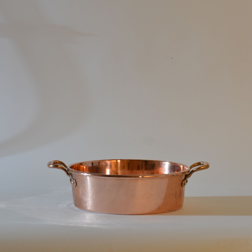 A wide circular 19th-century polished copper preserving pan with a rolled rim and twin riveted handles. View III