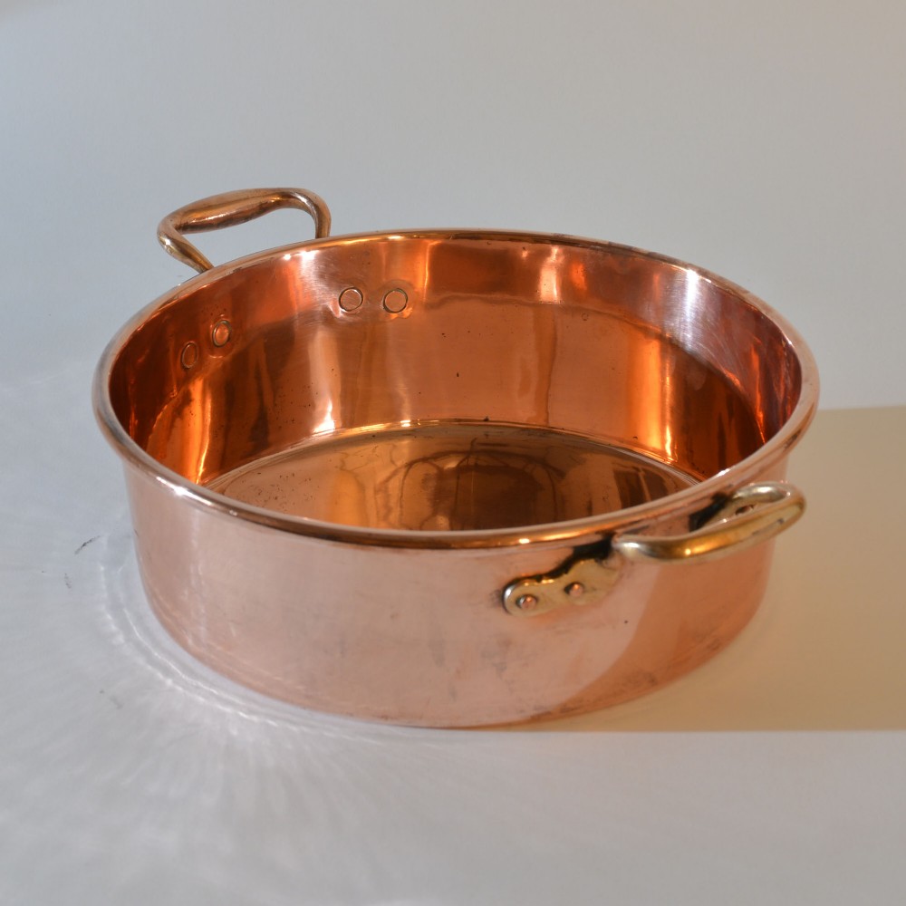 A wide circular 19th-century polished copper preserving pan with a rolled rim and twin riveted handles. View IV