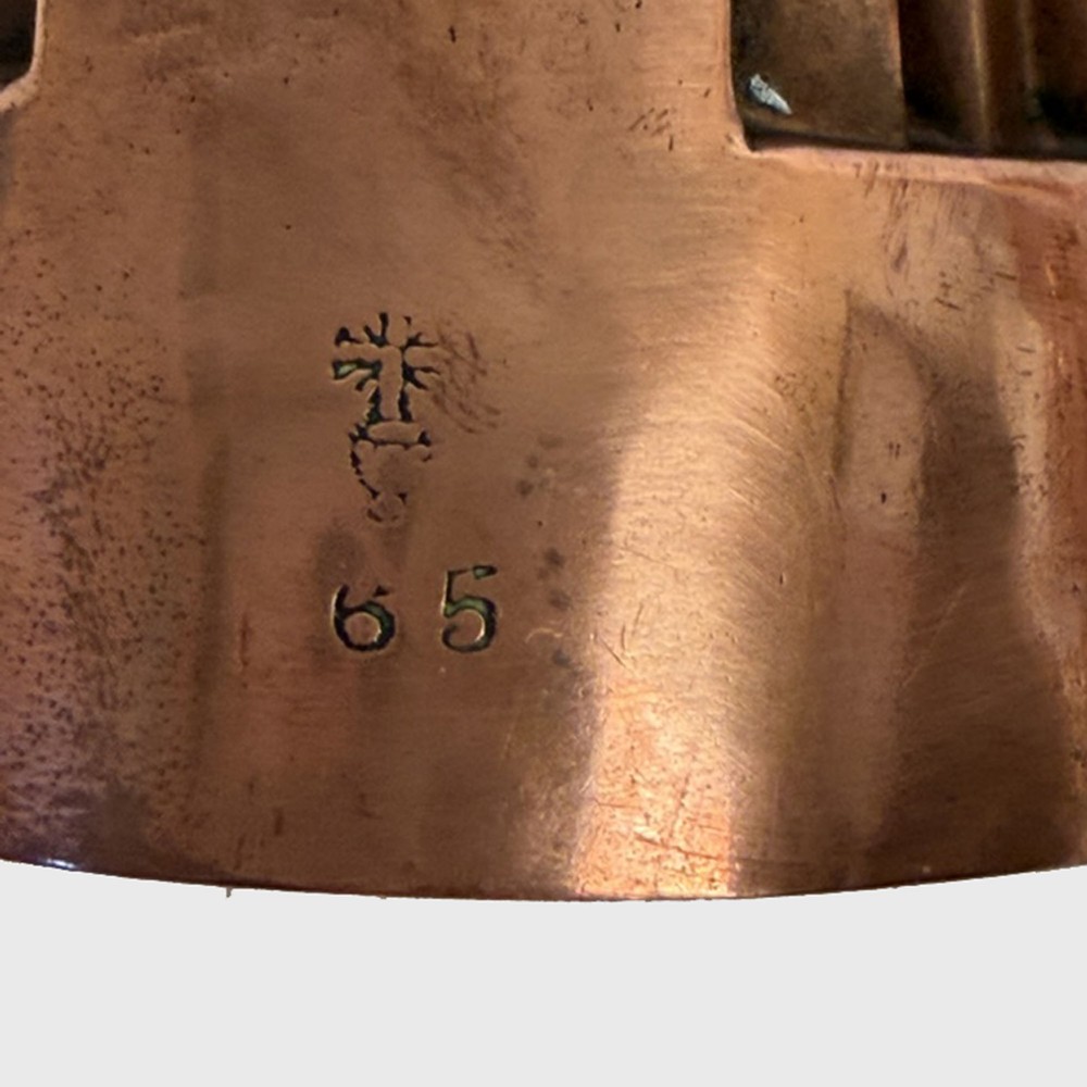A 19th century oval copper jelly mould featuring raised turrets and orb details on a stepped base. View II
