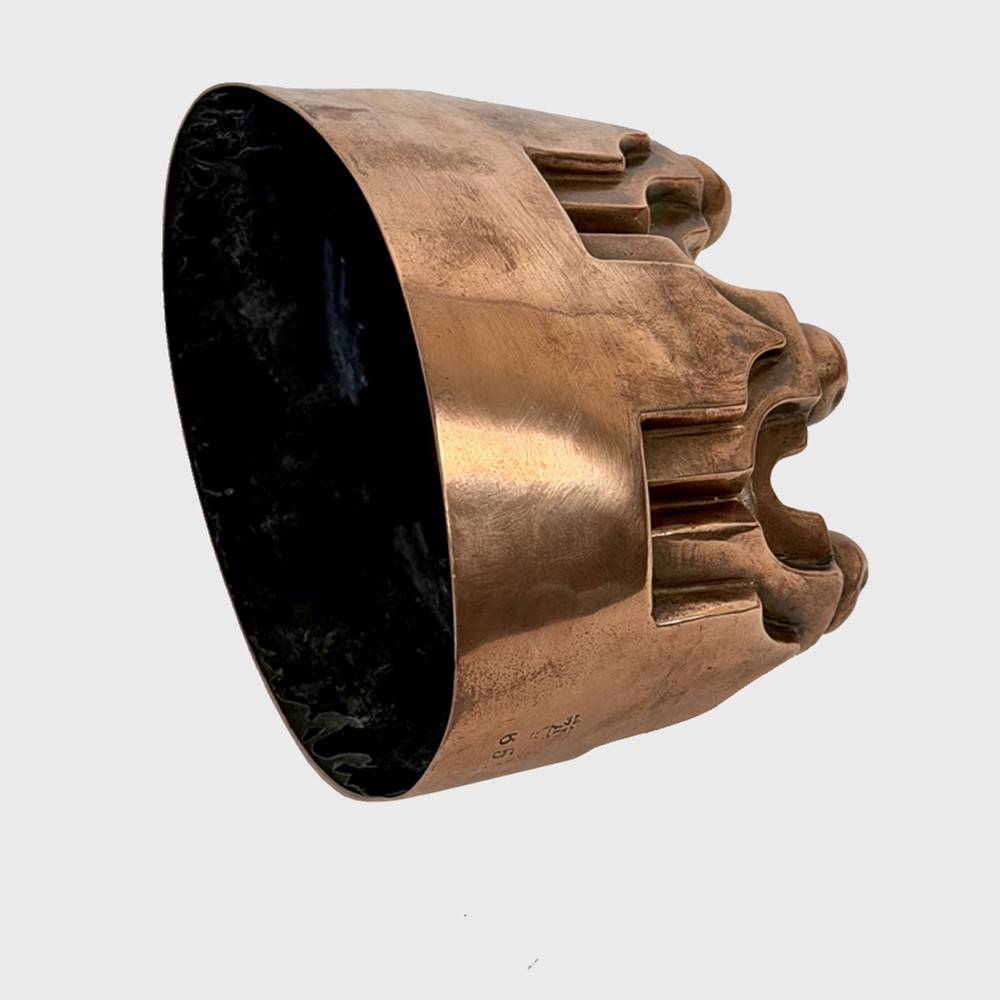 A 19th century oval copper jelly mould featuring raised turrets and orb details on a stepped base. View III