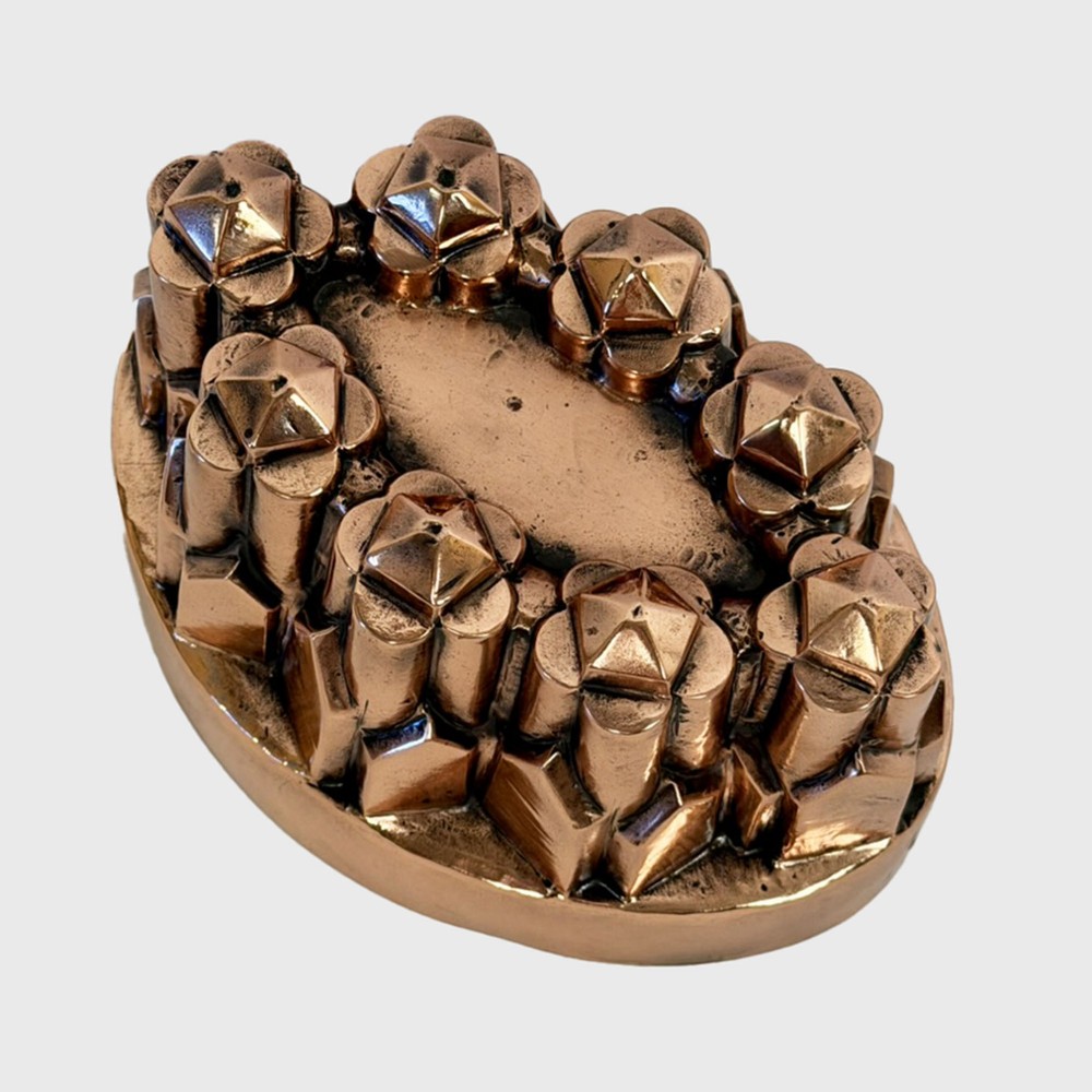 A nineteenth-century copper jelly mould featuring an oval base and architectural turret-shaped spires with pyramidal caps. View II