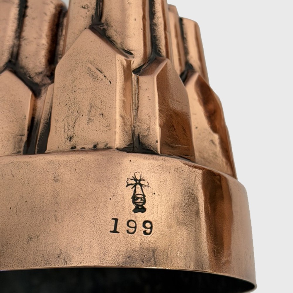A nineteenth-century copper jelly mould featuring an oval base and architectural turret-shaped spires with pyramidal caps. View III