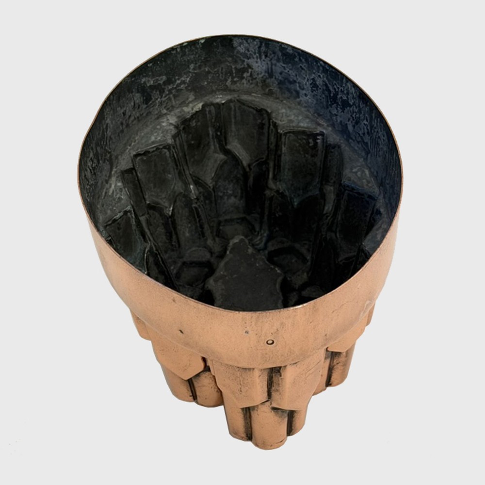 A nineteenth-century copper jelly mould featuring an oval base and architectural turret-shaped spires with pyramidal caps. View V