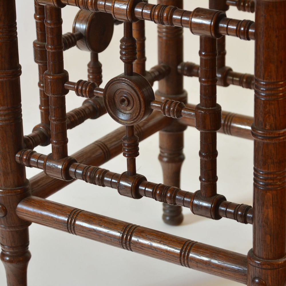 A late nineteenth-century oak side table designed in the Aesthetic Movement style with turned spindle sides and carved roundels. View IV