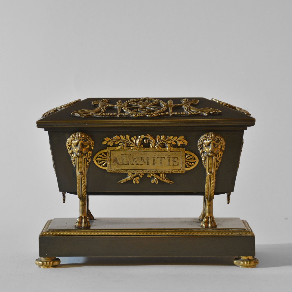 An 18th-century French Directoire casket-form inkstand in patinated black metal and gilt bronze, supported on lion monopodia legs with a inscribed plaque. View II