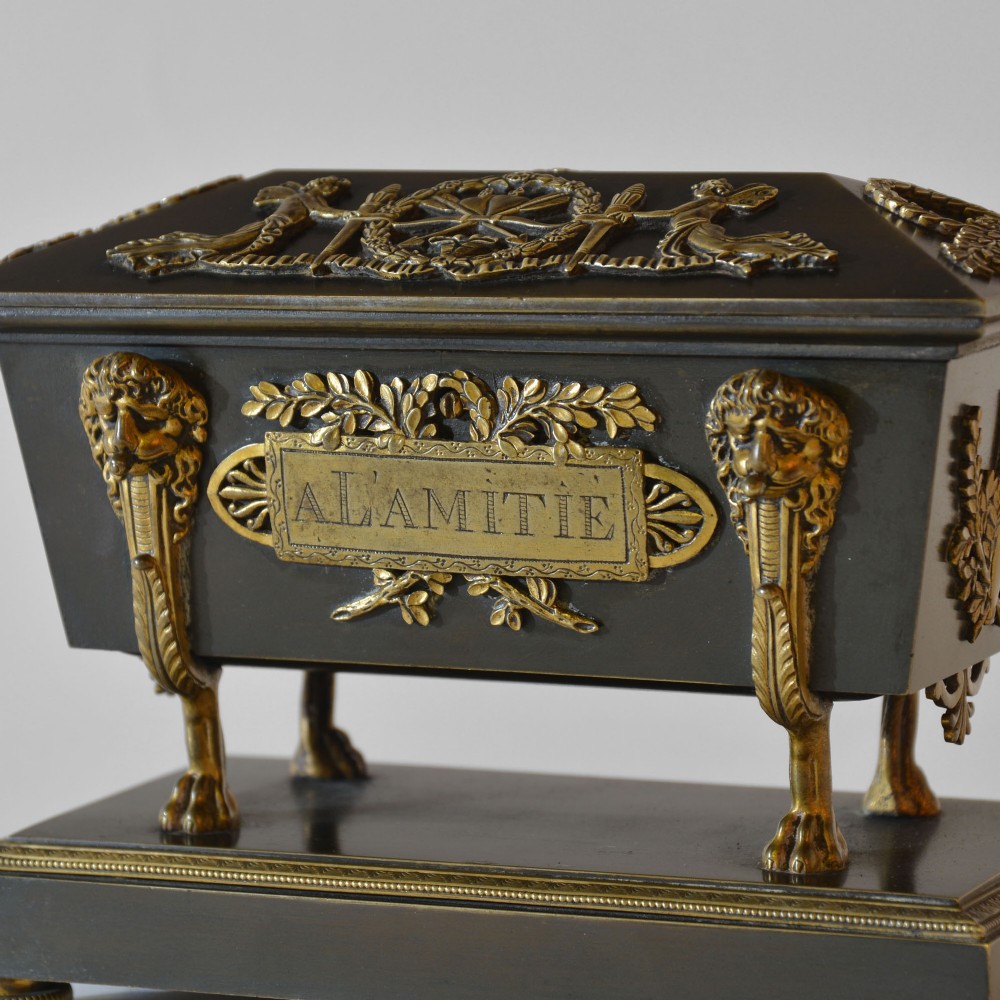 An 18th-century French Directoire casket-form inkstand in patinated black metal and gilt bronze, supported on lion monopodia legs with a inscribed plaque. View III