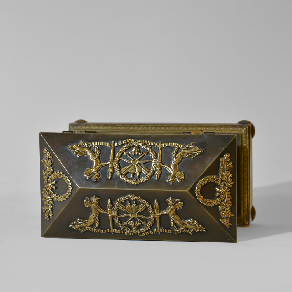 An 18th-century French Directoire casket-form inkstand in patinated black metal and gilt bronze, supported on lion monopodia legs with a inscribed plaque. View VII