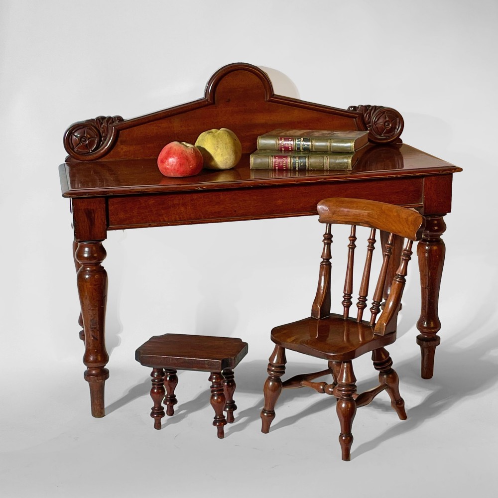 A mahogany scale model of a serving table featuring turned legs and a carved backboard crest. View II