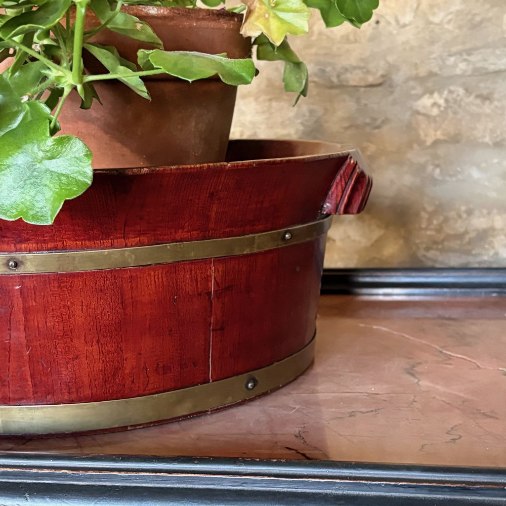 An oval 19th-century mahogany coopered jardiniere featuring horizontal brass binding bands and integrated wooden handles. View III