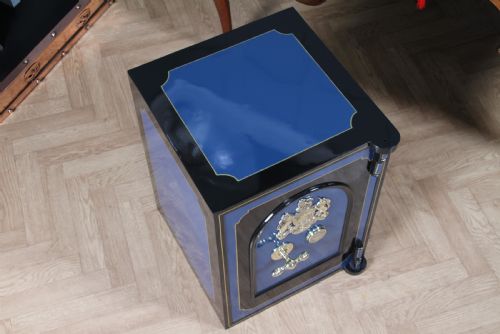 fig 3. A heavy restored Victorian cast iron safe featuring a deep blue and black lacquered exterior with gold pinstriping and a brass royal coat of arms crest.