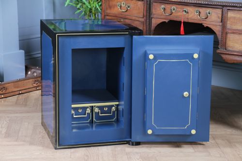 fig 4. A heavy restored Victorian cast iron safe featuring a deep blue and black lacquered exterior with gold pinstriping and a brass royal coat of arms crest.