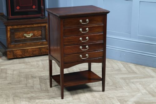 fig 1. An Edwardian mahogany music cabinet featuring five drop-front drawers with brass handles and a lower open shelf.