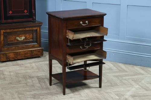 fig 2. An Edwardian mahogany music cabinet featuring five drop-front drawers with brass handles and a lower open shelf.