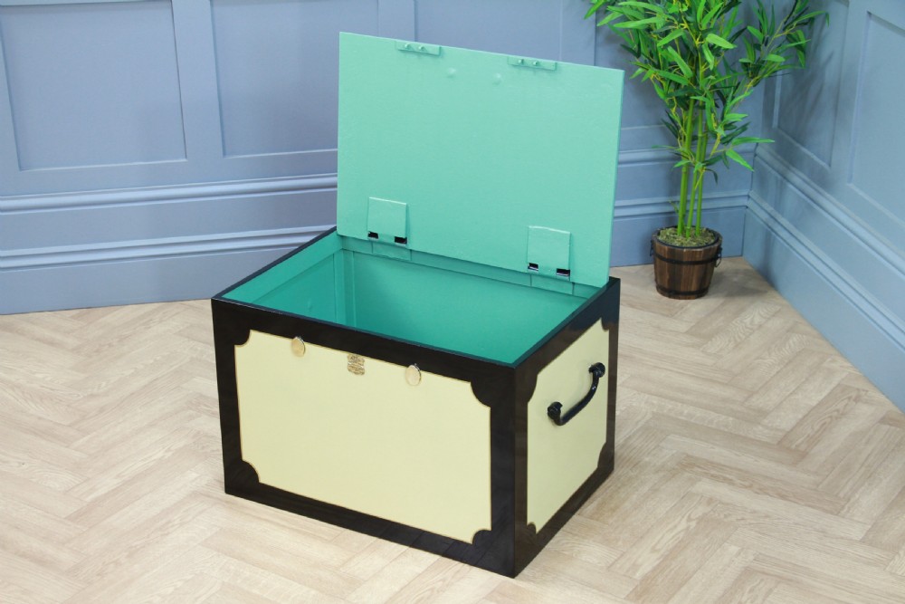 A restored Victorian George Price iron strong box with black painted edges, cream center panels, heavy iron handles, and a brass makers plaque. View II