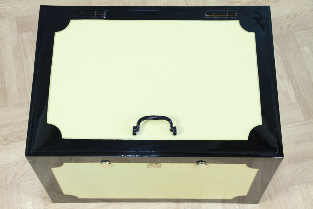 A restored Victorian George Price iron strong box with black painted edges, cream center panels, heavy iron handles, and a brass makers plaque. View VII