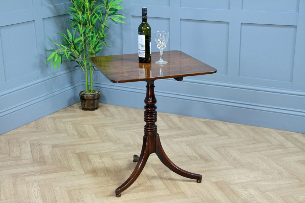 A Regency mahogany tilt-top wine table with a rounded square top, a turned column, and three splayed legs. View III