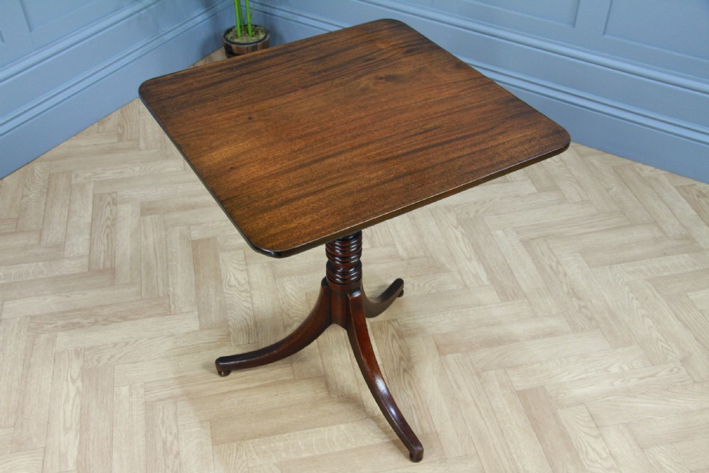 A Regency mahogany tilt-top wine table with a rounded square top, a turned column, and three splayed legs. View VIII