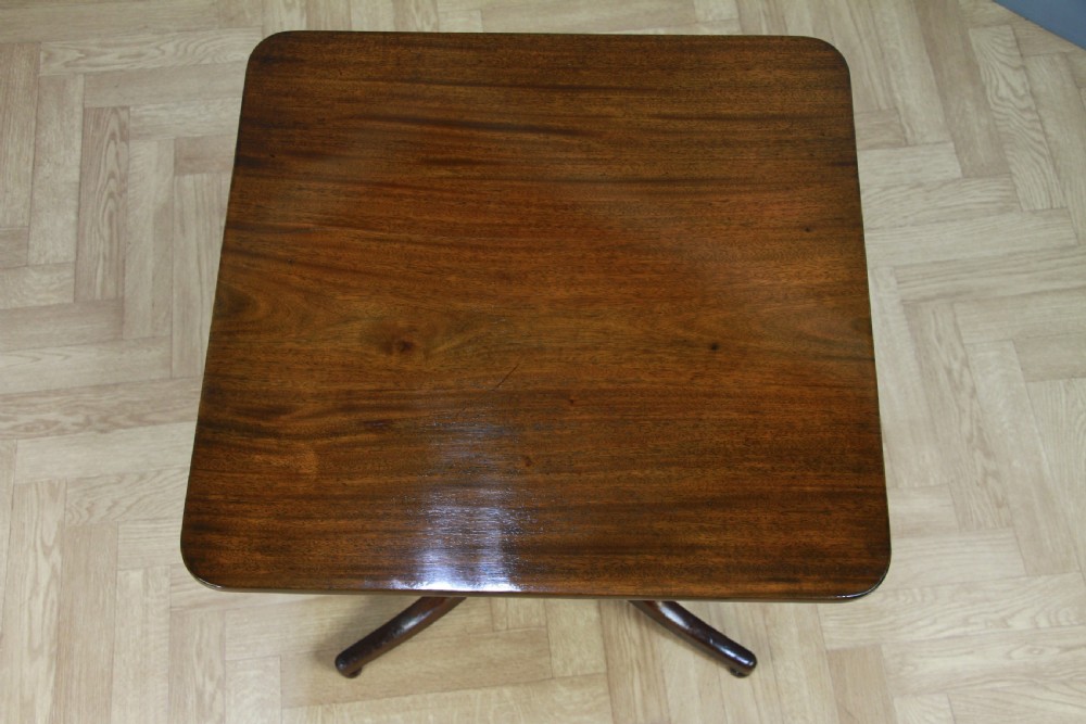 A Regency mahogany tilt-top wine table with a rounded square top, a turned column, and three splayed legs. View XI