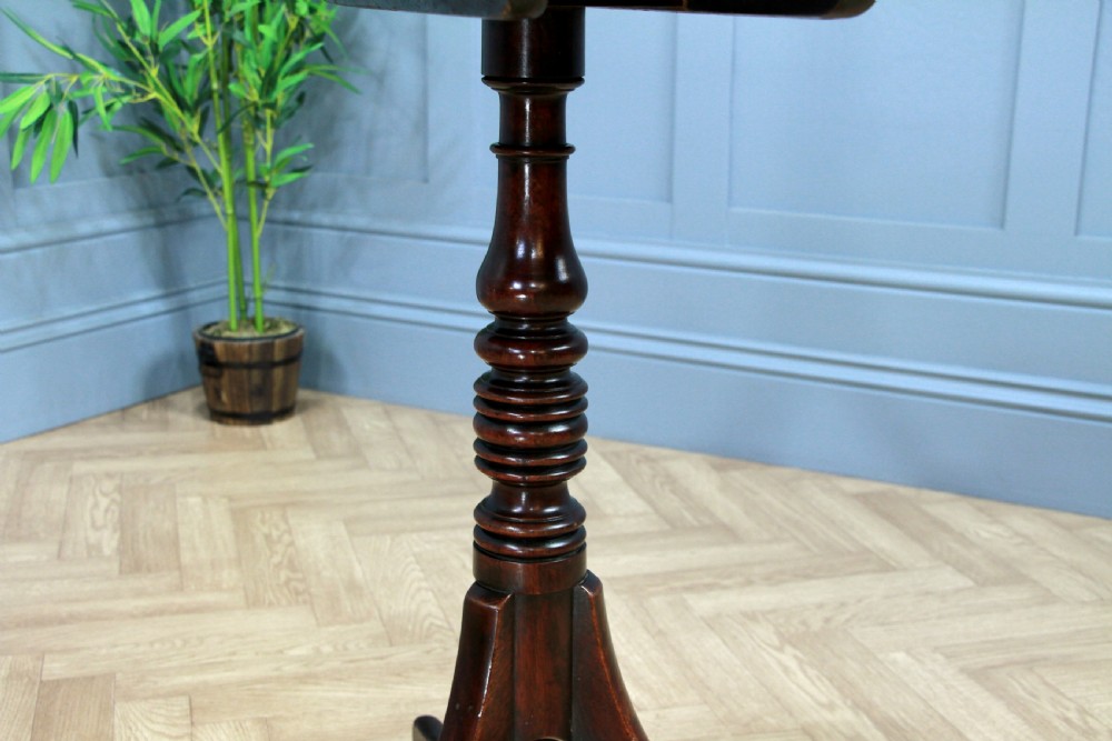 A Regency mahogany tilt-top wine table with a rounded square top, a turned column, and three splayed legs. View XII