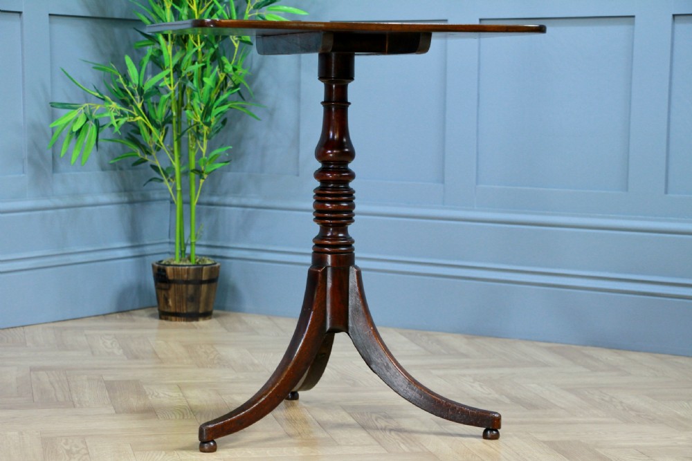 A Regency mahogany tilt-top wine table with a rounded square top, a turned column, and three splayed legs. View XIV