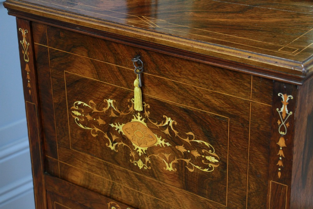 An Edwardian rosewood ladies bureau cabinet featuring marquetry inlay, a mirrored superstructure, a fall-front desk section, and a lower cupboard with a pleated fabric panel. View XVII