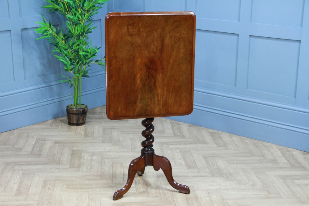 A Victorian flame mahogany tilt-top wine table with a rectangular top, spiral barley twist column, and tripod base. View II