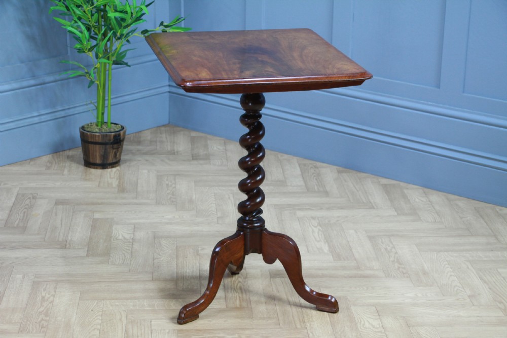 A Victorian flame mahogany tilt-top wine table with a rectangular top, spiral barley twist column, and tripod base. View V