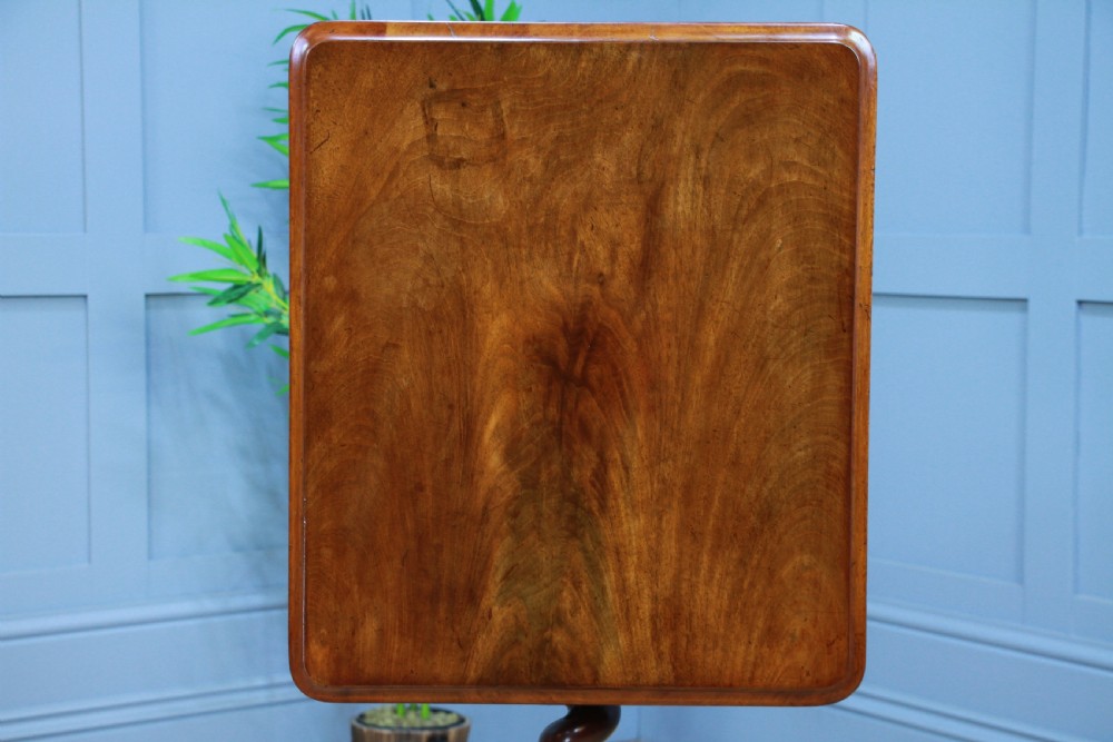 A Victorian flame mahogany tilt-top wine table with a rectangular top, spiral barley twist column, and tripod base. View VI