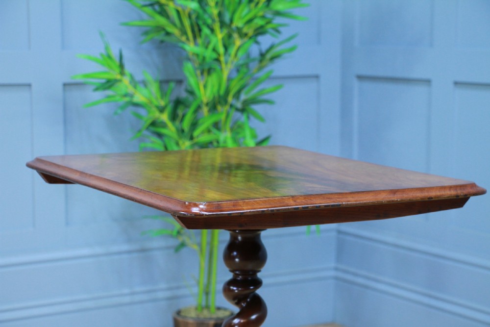 A Victorian flame mahogany tilt-top wine table with a rectangular top, spiral barley twist column, and tripod base. View X