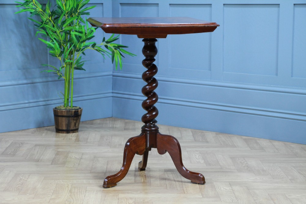 A Victorian flame mahogany tilt-top wine table with a rectangular top, spiral barley twist column, and tripod base. View XI