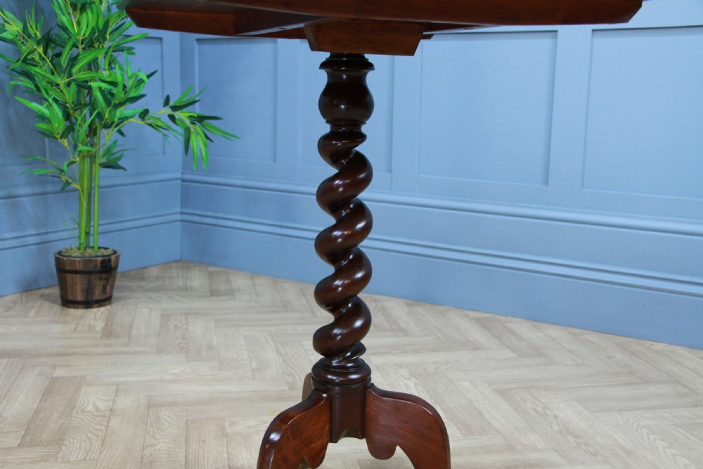 A Victorian flame mahogany tilt-top wine table with a rectangular top, spiral barley twist column, and tripod base. View XII