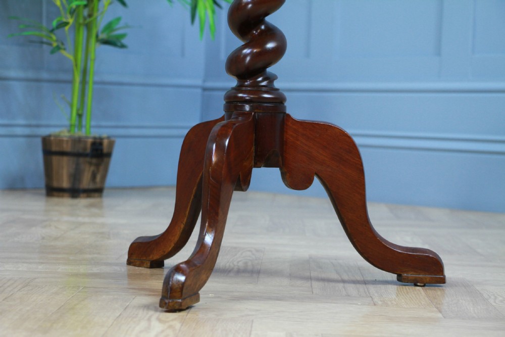 A Victorian flame mahogany tilt-top wine table with a rectangular top, spiral barley twist column, and tripod base. View XIII