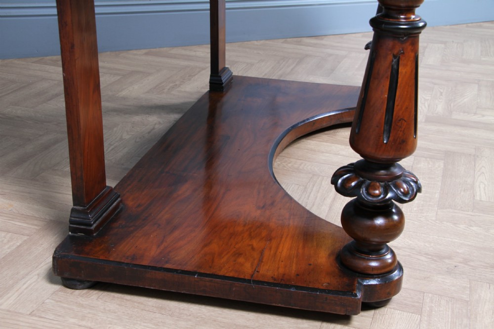 An antique Victorian burr walnut duchess dressing table featuring an integrated swing mirror, jewellery drawers, a curved piano top lid, turned front legs, and a plinth base. View XXII