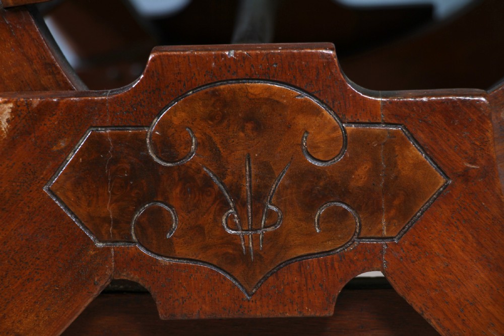 An Edwardian walnut platform rocking chair featuring cream button-backed upholstery and turned wooden spindles on a stationary crossed base. View XX
